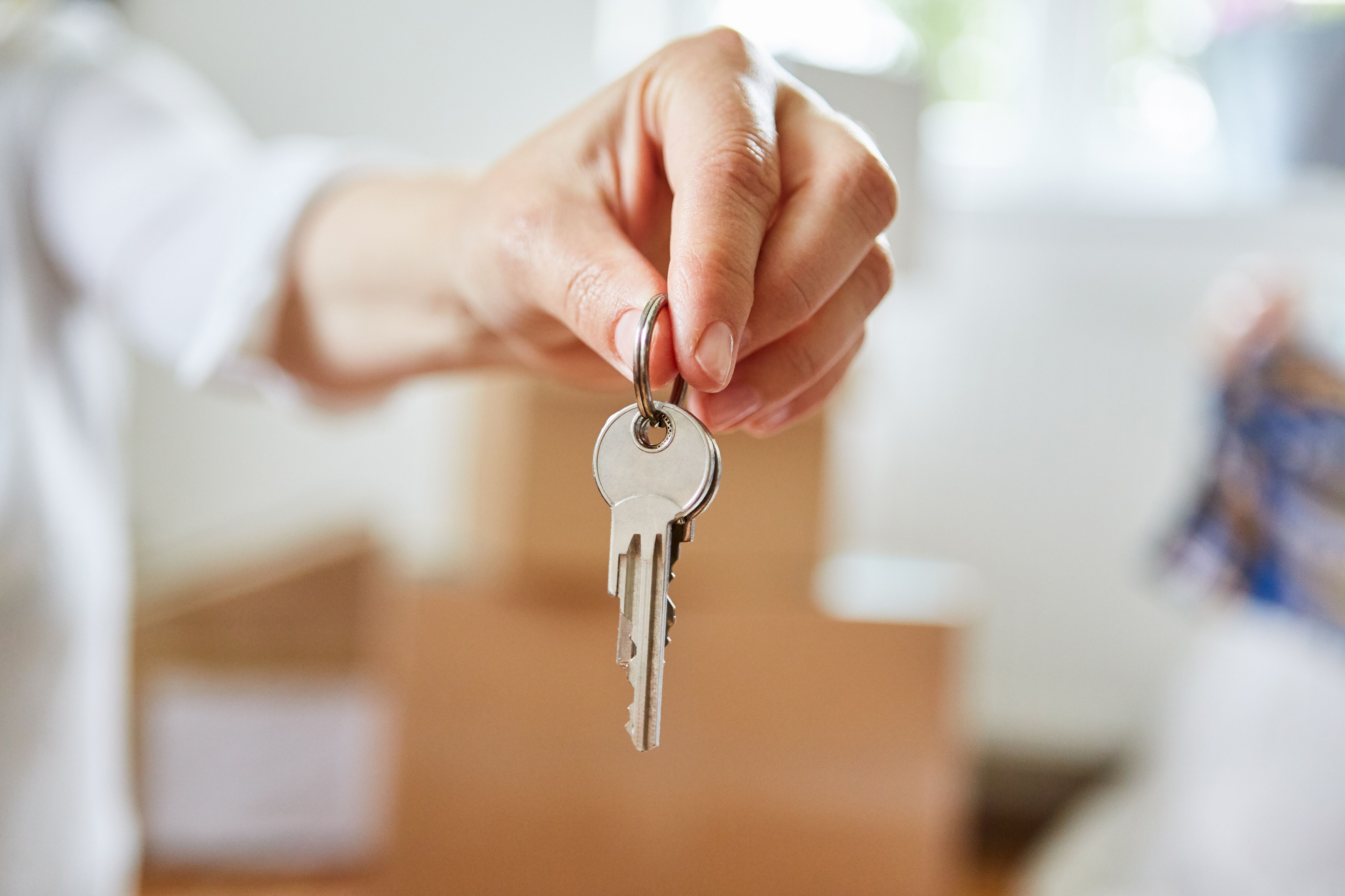 A closeup of a hand holding house keys.